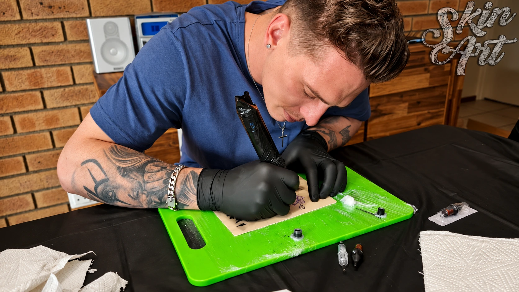 Tattoo instructor demonstrating on a practice surface