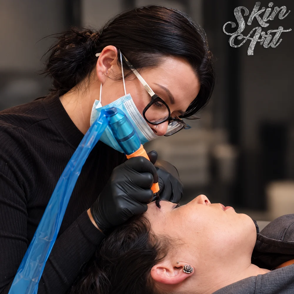 Permanent makeup artist working at a prepared treatment workstation