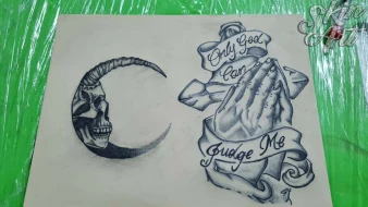 Moon and lettering tattoo exercises on synthetic skin