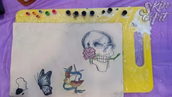 Skull and rose tattoo exercises on synthetic skin
