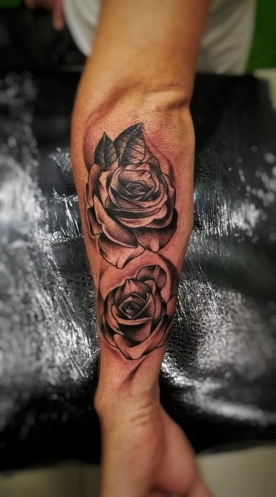 Student work: shaded rose tattoos on a forearm