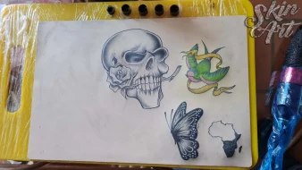 Skull and bird tattoo exercises on synthetic skin